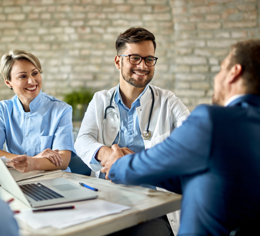 group-healthcare-workers-greeting-financial-advisor-during-meeting-office-focus-is-young-doctor 1